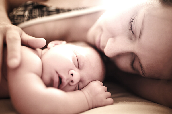Mom sleeping with newborn
